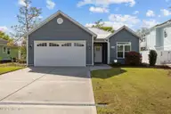 129 NW 11th Street, Oak Island, NC 28465 — 3-bedroom home in Pinners Point, Oak Island, NC, photo 1 of 63: FRONT