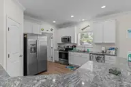 101 SW 28th Street, Oak Island, NC 28465 — 5-bedroom home in Pinners Point, Oak Island, NC, photo 16 of 56: Kitchen with Granite and SS Appliances