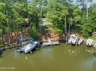 117 White Ash Drive, Pine Knoll Shores, NC 28512 — waterfront lot in Pine Knoll Association, Pine Knoll Shores, NC, photo 6 of 40: Dock at end of canal