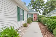 300 Sunset Oaks Lane 4, Sunset Beach, NC 28468 — 3-bedroom townhome in Sunset Oaks Garden Homes, Sunset Beach, NC, photo 6 of 44: Sidewalk to entry