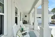 9599 Fallen Pear Lane NE, Leland, NC 28451 — 4-bedroom home in The Bluffs on the Cape Fear, Leland, NC, photo 7 of 72: Rocking chair front porch