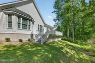 115 Windy Point, Sneads Ferry, NC 28460 — 3-bedroom home in Sea Pines North Shore, Sneads Ferry, NC, photo 4 of 42: Back Deck & Primary Bed Windows