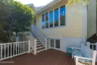 579 Coral Ridge Road, Pine Knoll Shores, NC 28512 — 4-bedroom waterfront home in Beacon's Reach, Pine Knoll Shores, NC, photo 6 of 62: Front Exterior & Deck Stairs