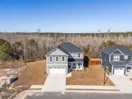 1029 Setting Sun Boulevard NE, Winnabow, NC 28479 — 5-bedroom home in Bell Meadows, Winnabow, NC, photo 1 of 43: 3-web-or-mls-DJI_20251211125013_0424_D