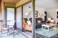 800 Saint Andrews Drive # 232, Pinehurst, NC 28374 — 2-bedroom condo in Linville Garden, Pinehurst, NC, photo 12 of 21: Loblolly Living Room- Deck