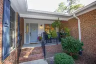 110 Saint Andrews Drive, Pinehurst, NC 28374 — 4-bedroom home in Unit 1, Pinehurst, NC, photo 4 of 59: Covered Front Porch