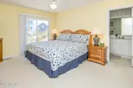 1131 S Shore Drive, Surf City, NC 28445 — 4-bedroom waterfront home in Horse Hammock, Surf City, NC, photo 15 of 40: Streetside North King Bedroom