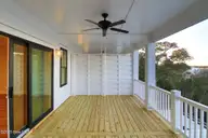 3804 Emerald Drive E, Emerald Isle, NC 28594 — 4-bedroom waterfront townhome in Emerald Isle By The Sea, Emerald Isle, NC, photo 15 of 46: Covered Porch off of Living Area