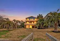102 SW Yacht Drive, Oak Island, NC 28465 — 4-bedroom waterfront home, Oak Island, NC, photo 1 of 46: imageTwlight