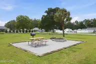 165 Long Pond Loop, Swansboro, NC 28584 — 2-bedroom waterfront condo in Cabins at Old Horse, Swansboro, NC, photo 21 of 25: Community Garden Firepit Grilling Area