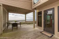 111 Dogwood Circle, Pine Knoll Shores, NC 28512 — 4-bedroom waterfront home in Pine Knoll Association, Pine Knoll Shores, NC, photo 23 of 52: Patio with entrance to living room