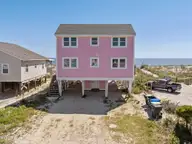 601 E Beach Drive, Oak Island, NC 28465 — 4-bedroom waterfront home in E. Long Beach, Oak Island, NC, photo 1 of 44: 1-web-or-mls-DJI_20250903145101_0384_D