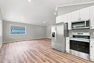 157 Long Pond Loop, Swansboro, NC 28584 — 2-bedroom waterfront condo in Cabins at Old Horse, Swansboro, NC, photo 5 of 28: Living Area & Kitchen