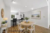 7601 Windward Drive, New Bern, NC 28560 — 3-bedroom waterfront condo in Fairfield Harbour, New Bern, NC, photo 14 of 52: Dining Area with AI Generated Furnishing
