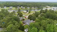 132 42 Quail Woods Drive, New Bern, NC 28560 — lot in Quail Woods Village, Ltd, New Bern, NC, photo 2 of 6: 11-web-or-mls-DJI_20260511130311_0364_D