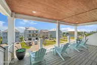 133 Sound Point Drive, Harkers Island, NC 28531 — 3-bedroom waterfront home in Cape Point Village, Harkers Island, NC, photo 6 of 61: Covered deck with sound views