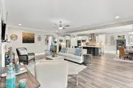 1068 Snowden Road, Wilmington, NC 28412 — 3-bedroom home in Riverlights - Del Webb, Wilmington, NC, photo 16 of 74: 16_living area, hallway & dining area