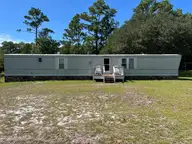 112 Pettiford Road, Peletier, NC 28584 — 3-bedroom waterfront manufactured home in Pettiford Point, Peletier, NC, photo 1 of 19: front
