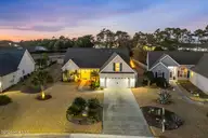 5004 Summerswell Lane, Southport, NC 28461 — 4-bedroom home in Seaspray Cove, Southport, NC, photo 2 of 35: Twilight aerial front