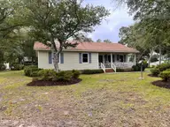 1506 E Oak Island Drive, Oak Island, NC 28465 — 3-bedroom home in Tranquil Harbour Island, Oak Island, NC, photo 1 of 56