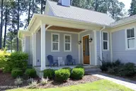 166 Champions Ridge Drive, Southern Pines, NC 28387 — 3-bedroom home in Mid South Club, Southern Pines, NC, photo 2 of 45: 06FrontPorch