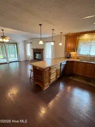 515 Fairway Drive W, Sunset Beach, NC 28468 — 3-bedroom home in Sea Trail Plantation, Sunset Beach, NC, photo 16 of 25: kitchen to living room and carolina rom