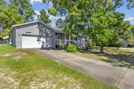 4580 Squirrel Avenue NW, Shallotte, NC 28470 — 3-bedroom home in Wildwood Village, Shallotte, NC, photo 3 of 30: Mature trees in front yard