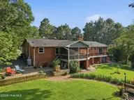 22 Pine Lake Drive, Whispering Pines, NC 28327 — 3-bedroom waterfront home in Pine Lakes, Whispering Pines, NC, photo 4 of 53: Terraced Backyard Leading to Pine Lake