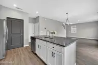 825 Seathwaite Lane SE, Leland, NC 28451 — 4-bedroom home in Hawkeswater at the River, Leland, NC, photo 22 of 55: 825SeathwaiteLaneSE-16 Kitchen island vi