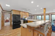 111 Dogwood Circle, Pine Knoll Shores, NC 28512 — 4-bedroom waterfront home in Pine Knoll Association, Pine Knoll Shores, NC, photo 16 of 52: Kitchen with bar seating