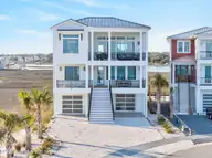 47 Grand View Drive, Ocean Isle Beach, NC 28469 — 8-bedroom waterfront home in The Pointe at Ocean Isle Beach, Ocean Isle Beach, NC, photo 5 of 71: DJI_20260314054633_0031_D_47GRAND