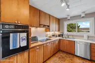 402 Dolphin Street, Sunset Beach, NC 28468 — 3-bedroom waterfront home, Sunset Beach, NC, photo 24 of 53: Kitchen with wall over & cooktop