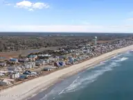 1025 W Beach Drive, Oak Island, NC 28465 — 3-bedroom waterfront home, Oak Island, NC, photo 2 of 45: 11-web-or-mls-DJI_20260122122152_0279_D