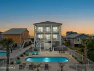 1012 W Beach Drive, Oak Island, NC 28465 — 5-bedroom waterfront home in Long Beach, Oak Island, NC, photo 1 of 70: 1-web-or-mls-CAMMediaLLC.com (1 of 83)