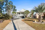 1404 W Yacht Drive, Oak Island, NC 28465 — 3-bedroom waterfront home in Pinners Point, Oak Island, NC, photo 1 of 46: Front