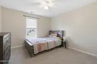 404 Hidden Oaks Drive, Jacksonville, NC 28546 — 3-bedroom home in Hunters Creek, Jacksonville, NC, photo 24 of 28: Cozy bedroom with rustic charm