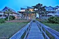 6008 W Beach Drive, Oak Island, NC 28465 — 6-bedroom waterfront home, Oak Island, NC, photo 7 of 75: 6008WestBeachDrive_twilight-7
