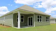 1307 Woodhouse Drive NW, Ash, NC 28420 — 3-bedroom home in Brunswick Plantation, Ash, NC, photo 3 of 23: Aria_H_Back_Side