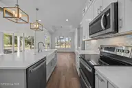 498 Genoes Point Road SW, Supply, NC 28462 — 3-bedroom waterfront home in Lockwood Folly, Supply, NC, photo 13 of 56: Kitchen with Center island and farm sink