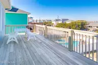 1131 S Shore Drive, Surf City, NC 28445 — 4-bedroom waterfront home in Horse Hammock, Surf City, NC, photo 21 of 40: Top Floor Poolside Sundeck II