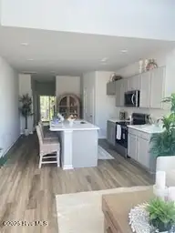 727 Palm Frond Way NW, Calabash, NC 28467 — 3-bedroom townhome in Calabash Palms, Calabash, NC, photo 10 of 27: entrance view of island kitchen