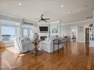 6414 Ocean Drive, Emerald Isle, NC 28594 — 5-bedroom waterfront home in Sea Crest, Emerald Isle, NC, photo 11 of 56: Living room opens to kitchen and din