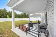 1080 Ben Thomas Drive NE, Leland, NC 28451 — 4-bedroom home in Coastal Haven, Leland, NC, photo 21 of 45: Covered Patio (2)