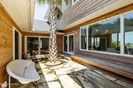 10104 Sea Breeze Drive, Emerald Isle, NC 28594 — 5-bedroom waterfront home in Lands End, Emerald Isle, NC, photo 17 of 62: Patio Breezeway