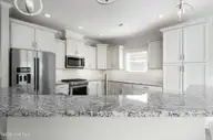 8983 Mango Bay Court NE, Leland, NC 28451 — 4-bedroom townhome in Compass Pointe, Leland, NC, photo 13 of 53: Stainless Steel Appliances/Gas Range