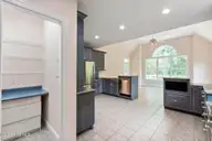 86 Plantation Passage Drive SE, Bolivia, NC 28422 — 4-bedroom waterfront home in Winding River Plantation, Bolivia, NC, photo 16 of 77: Pantry and Kitchen