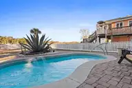 1404 W Yacht Drive, Oak Island, NC 28465 — 3-bedroom waterfront home in Pinners Point, Oak Island, NC, photo 23 of 46: In-ground pool 2