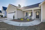 9579 Lily Pond Court NE, Leland, NC 28451 — 3-bedroom home in Lily Pond, Leland, NC, photo 5 of 33: Covered front porch, 2-car garage