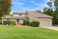 152 Arborvitae Drive, Pine Knoll Shores, NC 28512 — 3-bedroom waterfront home in Pine Knoll Association, Pine Knoll Shores, NC, photo 1 of 61: Front of house