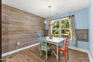 117 NE 19th Street, Oak Island, NC 28465 — 3-bedroom home in Tranquil Harbor, Oak Island, NC, photo 17 of 77: Dining Room has wooden accent wall